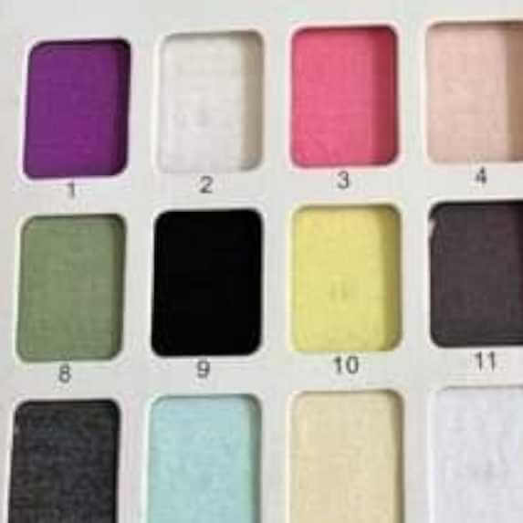 Palette of fabric swatches with various shades including celadon green, representing Wren Ivy Co.'s range of colors for bamboo baby clothing.